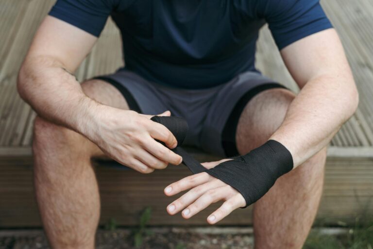 Close-up of a boxer preparing with hand wraps. Focus on wrapping technique.