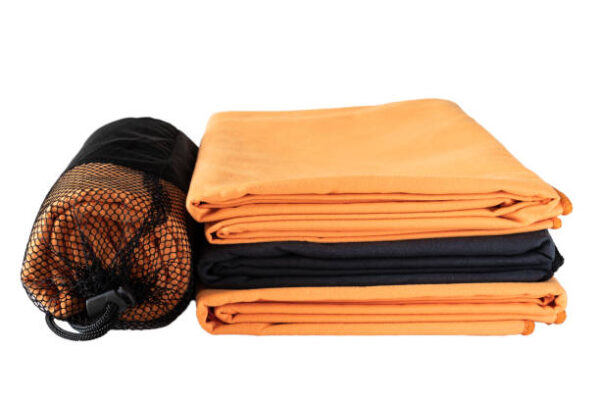 Black, orange towels isolated on white background