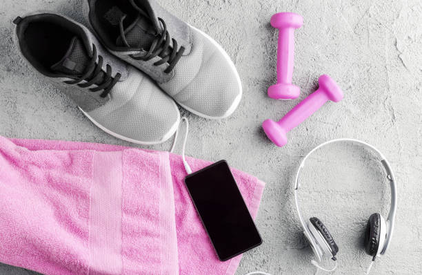 Flat lay fitness composition. sneakers, smartphone and headphones